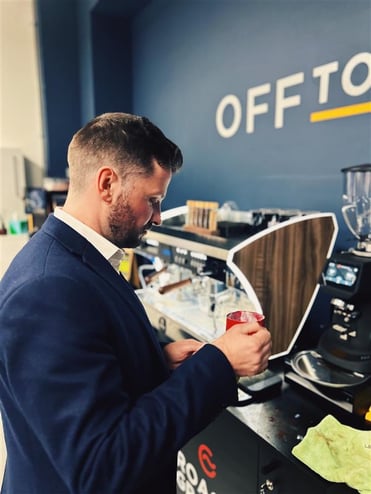 Business man making a hot drink with a self-serve coffee machine from Roast & Ground