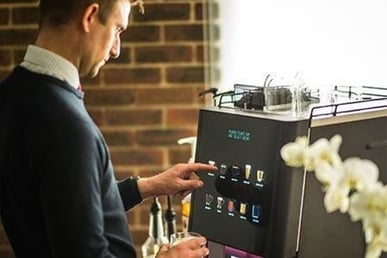 man-operating-coffee-machine